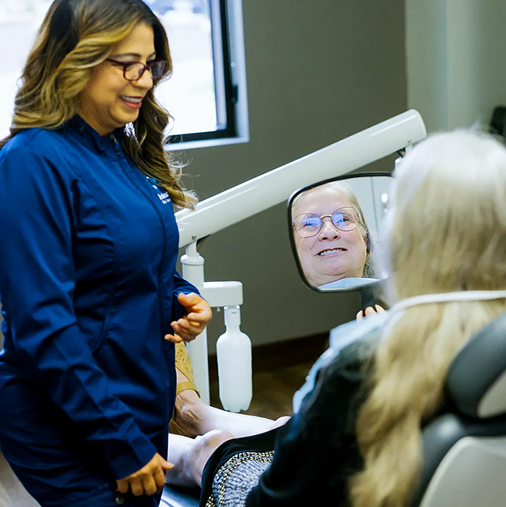 A dentist from the team attending to a patient in the Aesthetic Dental Center's treatment room