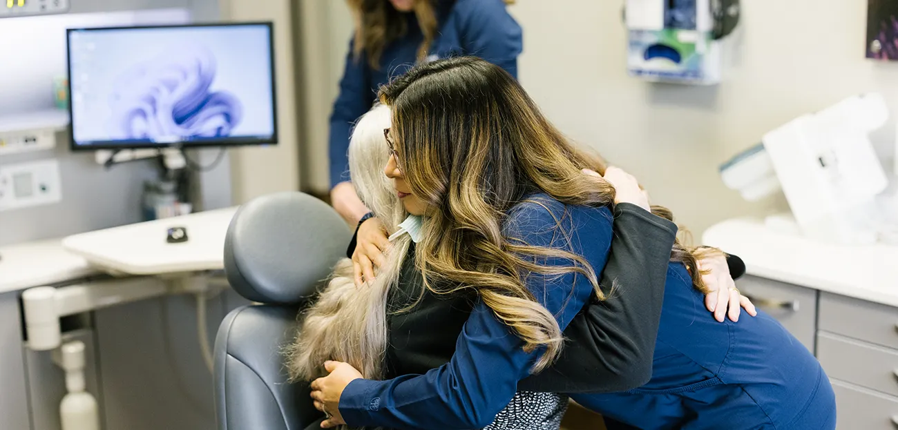 Aesthetic Dental Team Member Hugging A Patient