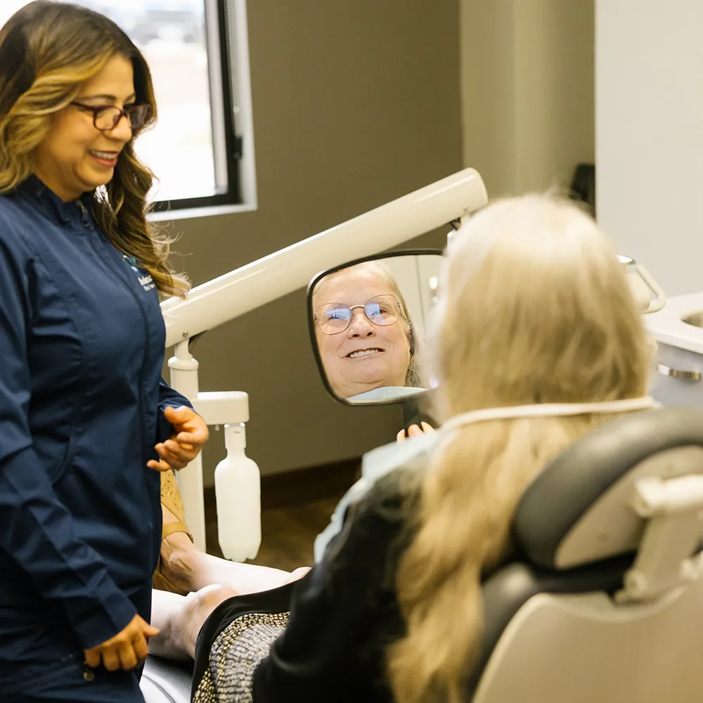 Dental Implants Patient Smiling In Mirror