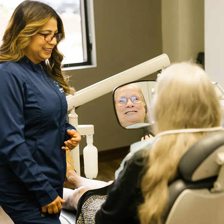 Real Dental Implants Patient Smiling In Mirror