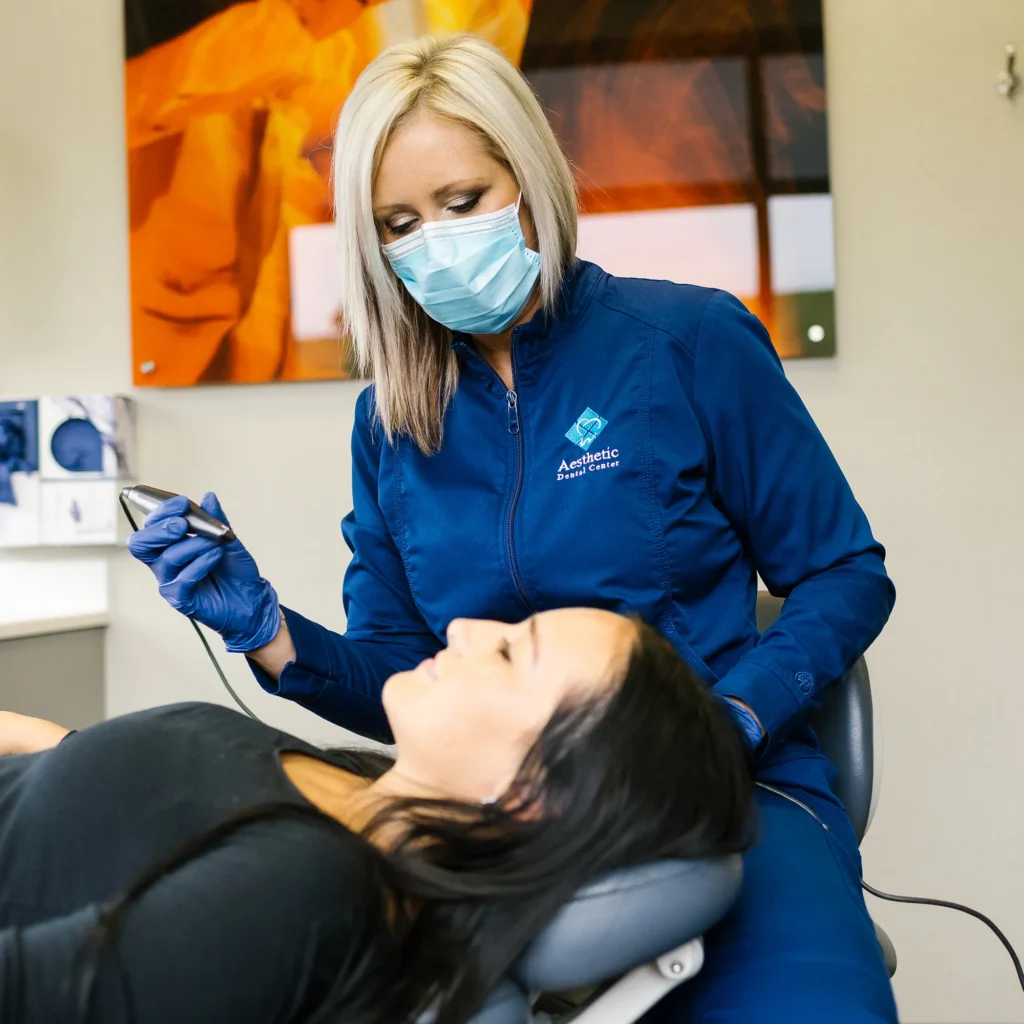 Dentist Preparing For Tooth Extraction While Patient Waits In Chair