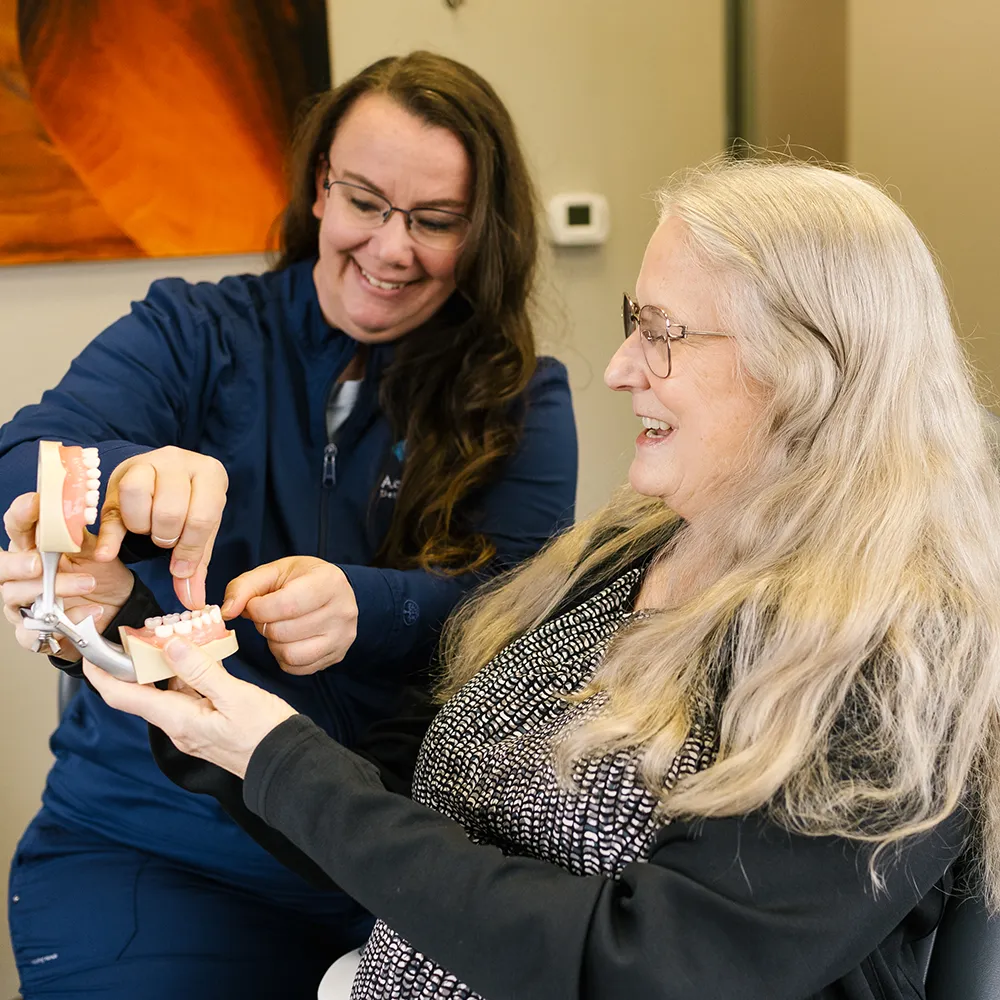 Team Member Assisting Patient With Dentures
