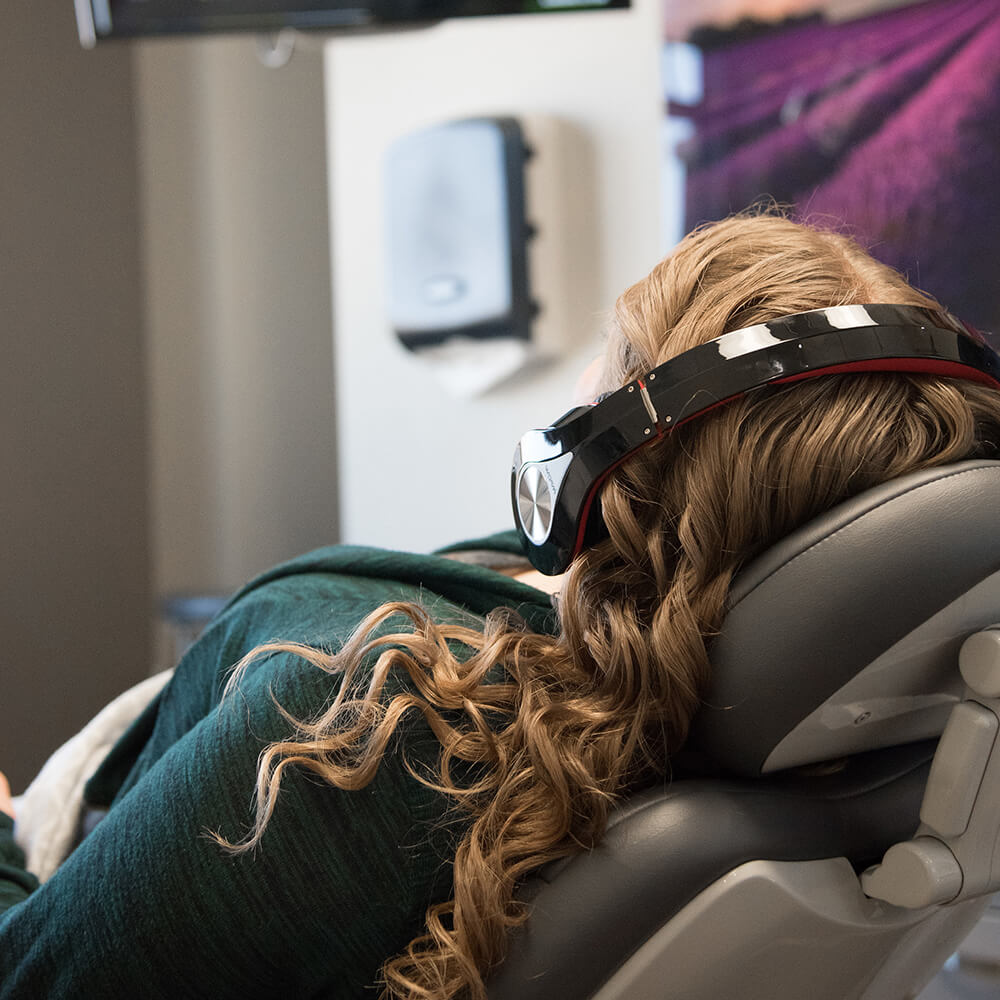 Sedation Dentistry - Patient With Headphones Watching Netflix