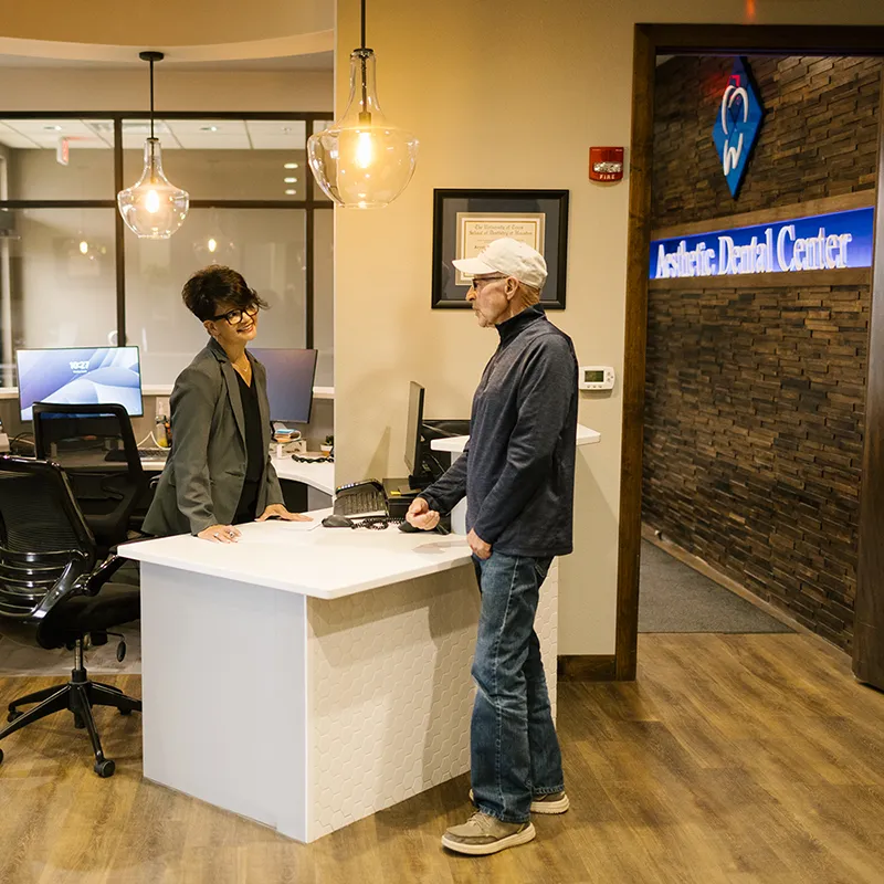 Patient Being Greeted at Reception Area
